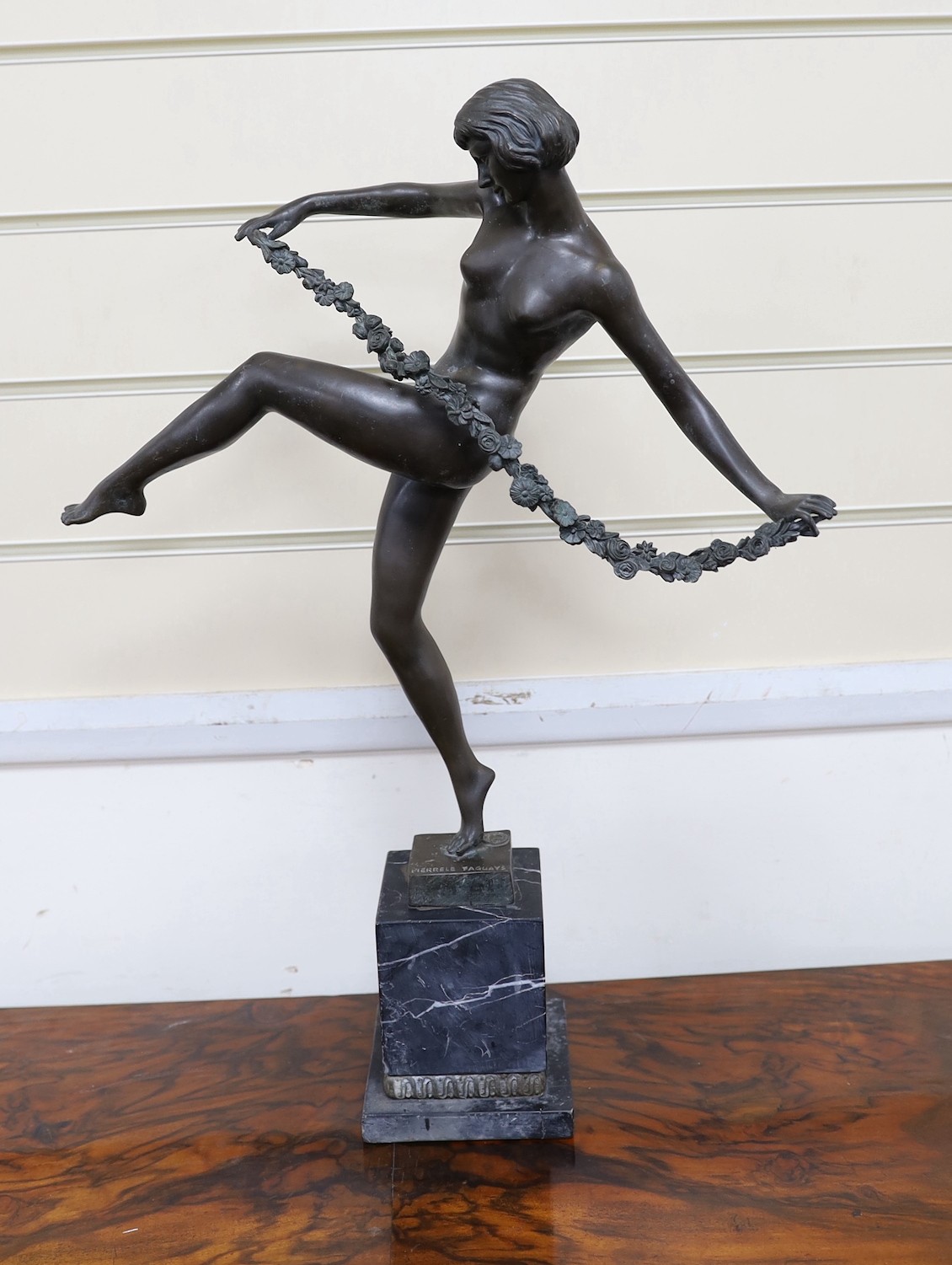 After Faguays, bronze of a female dancer with a swag of flowers, 54 cms high